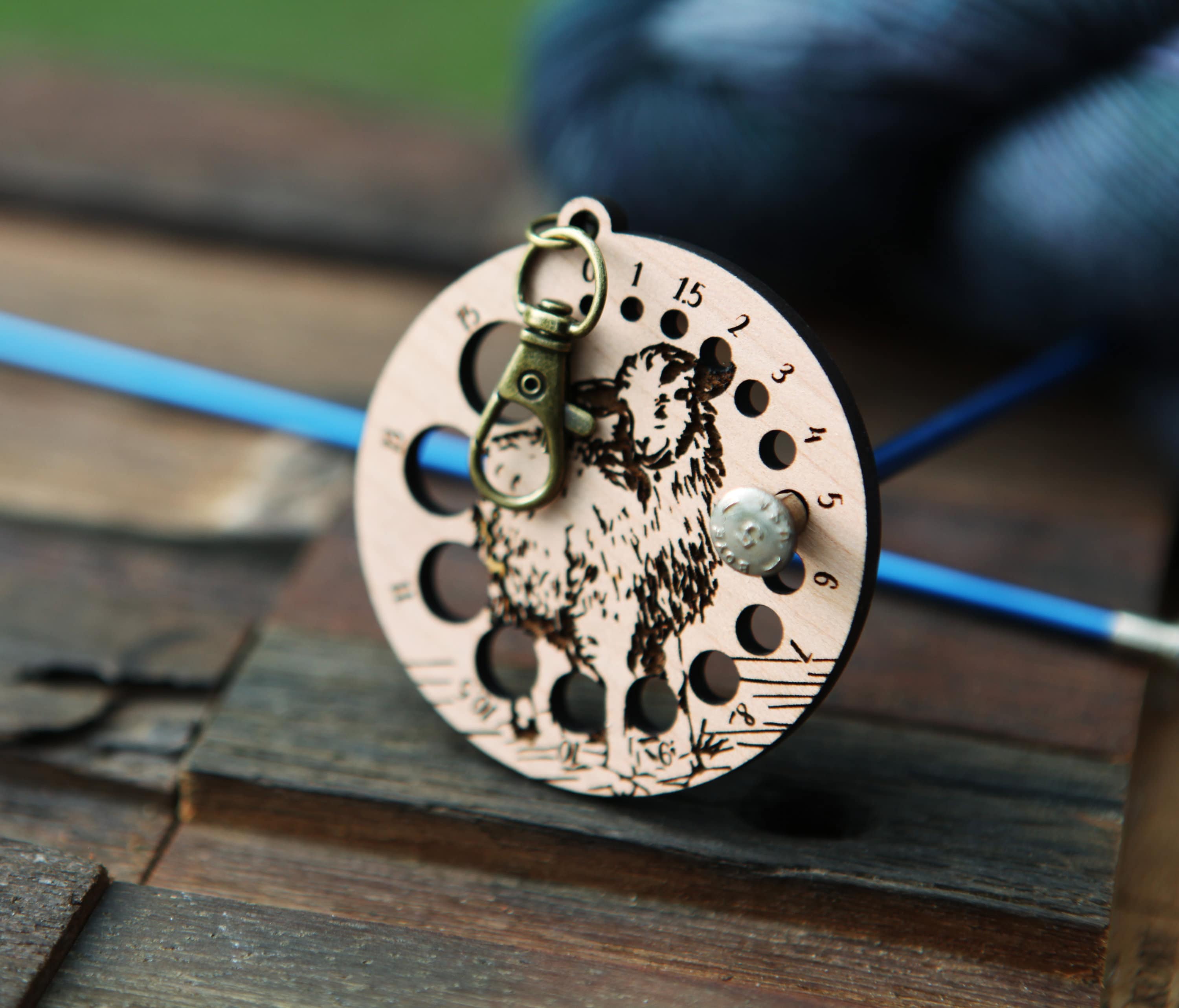 Knitting Needle Gauge Guide with a sheep standing on a grassy hill - Cherry wood with bronze clasp