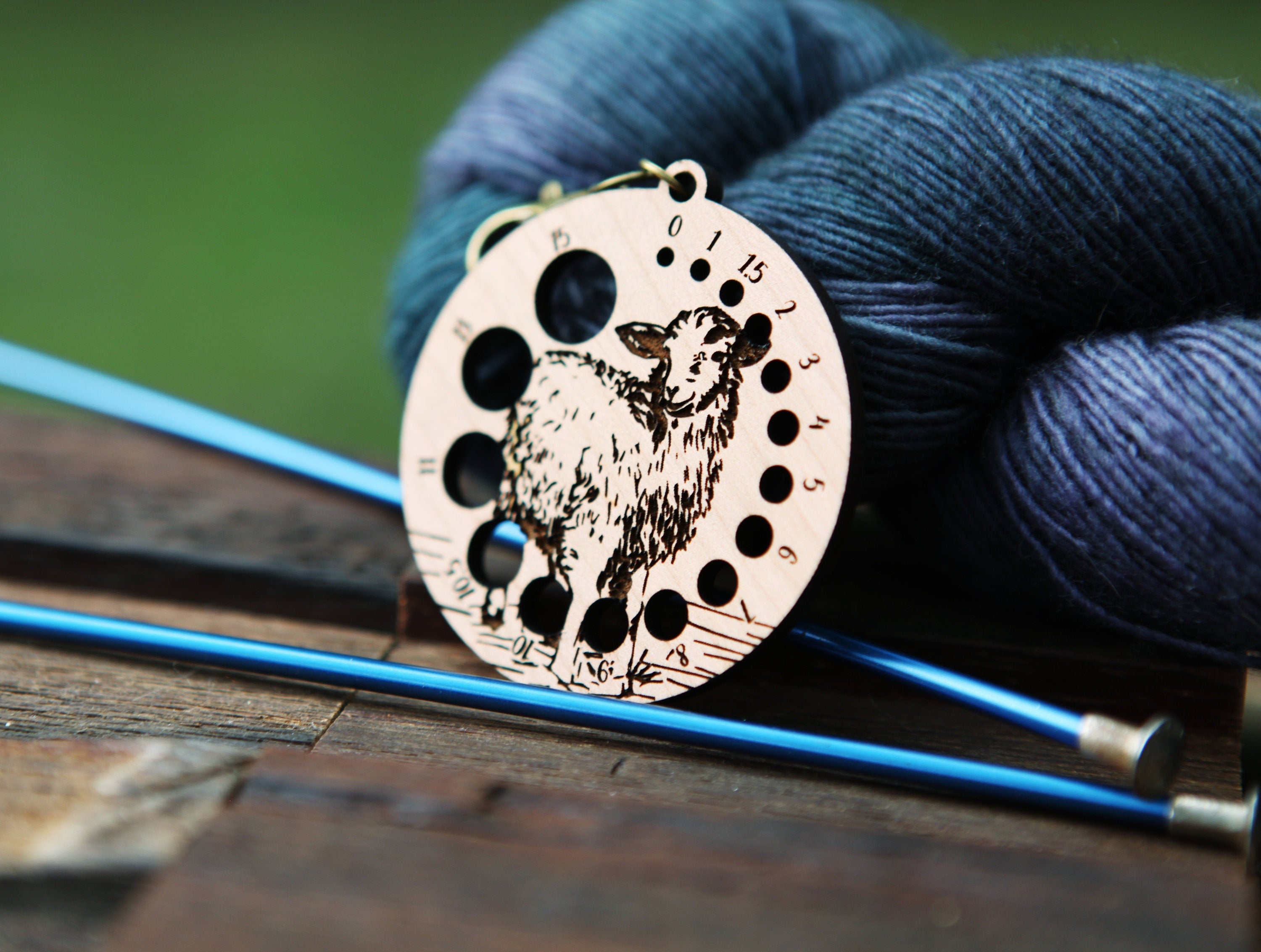 Knitting Needle Gauge Guide with a sheep standing on a grassy hill - Cherry wood with bronze clasp