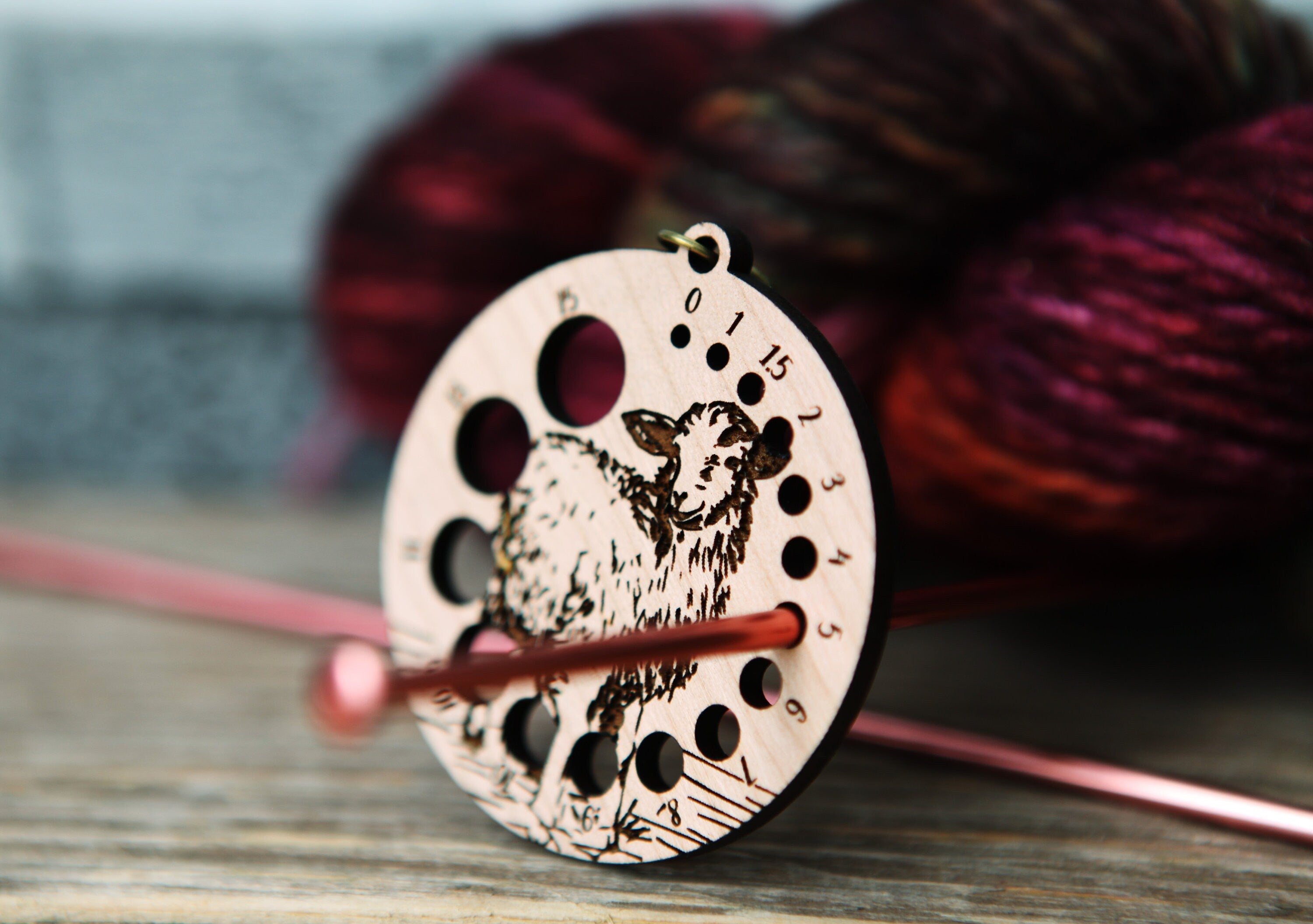 Knitting Needle Gauge Guide with a sheep standing on a grassy hill - Cherry wood with bronze clasp