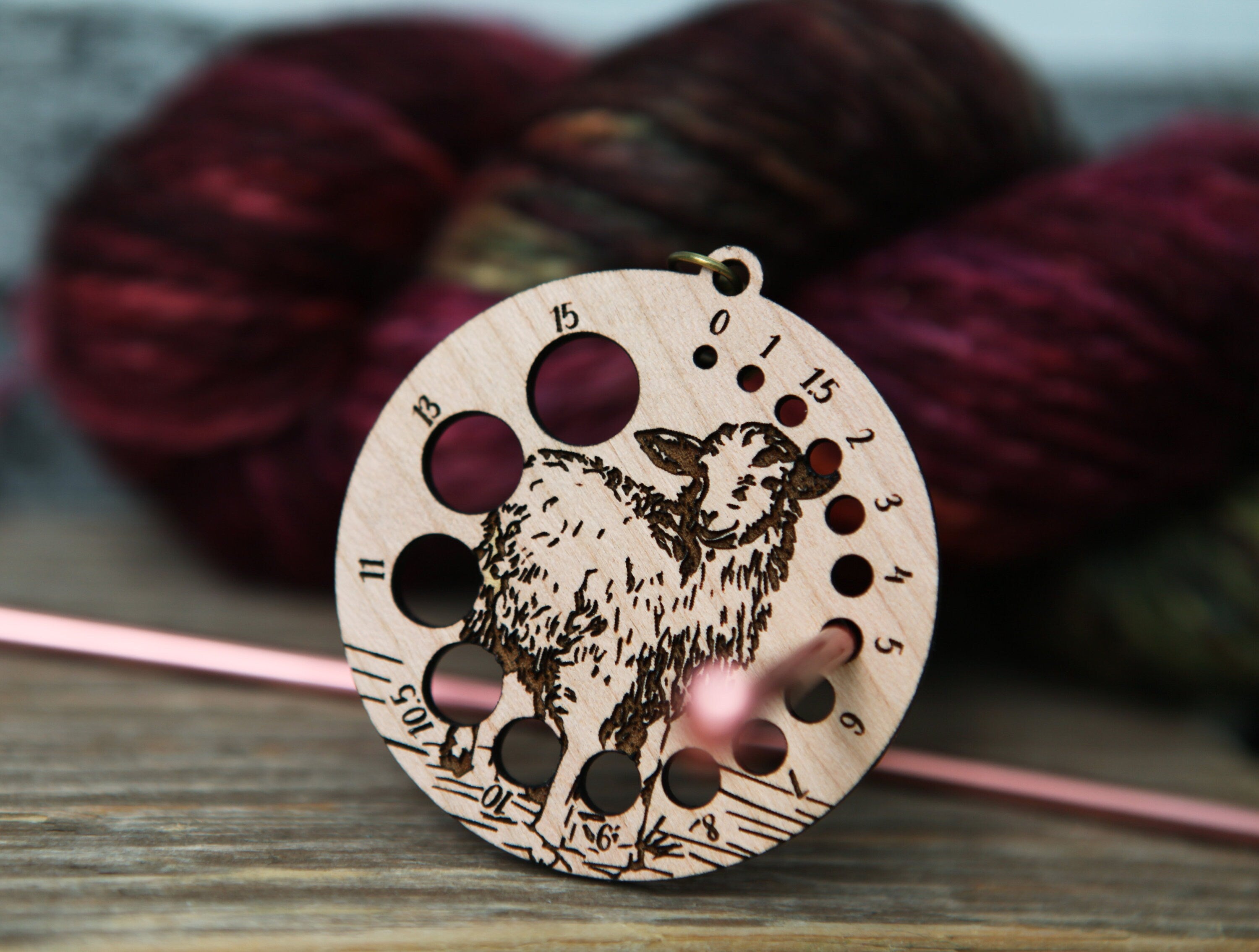 Knitting Needle Gauge Guide with a sheep standing on a grassy hill - Cherry wood with bronze clasp