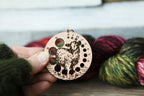 Knitting Needle Gauge Guide with a sheep standing on a grassy hill - Cherry wood with bronze clasp